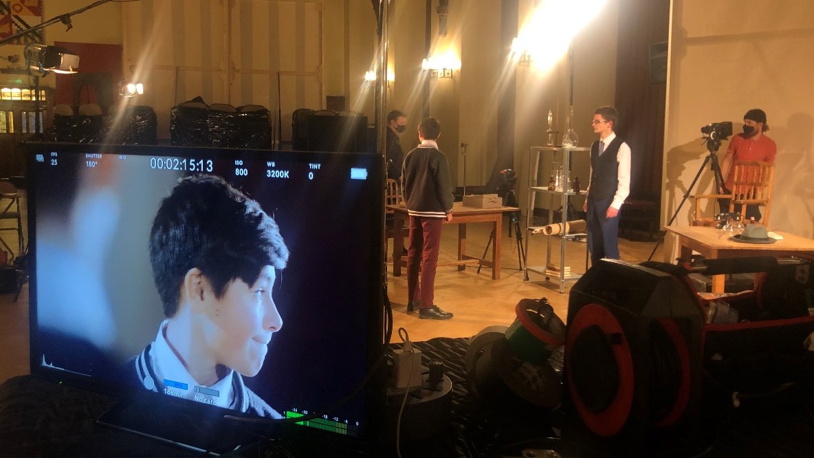 It's a Wonderful Life: a behind the scenes shot showing a TV screen with a live feed from a camera showing a close-up of one of the actors performing in the scene behind, with another camera visible beside them