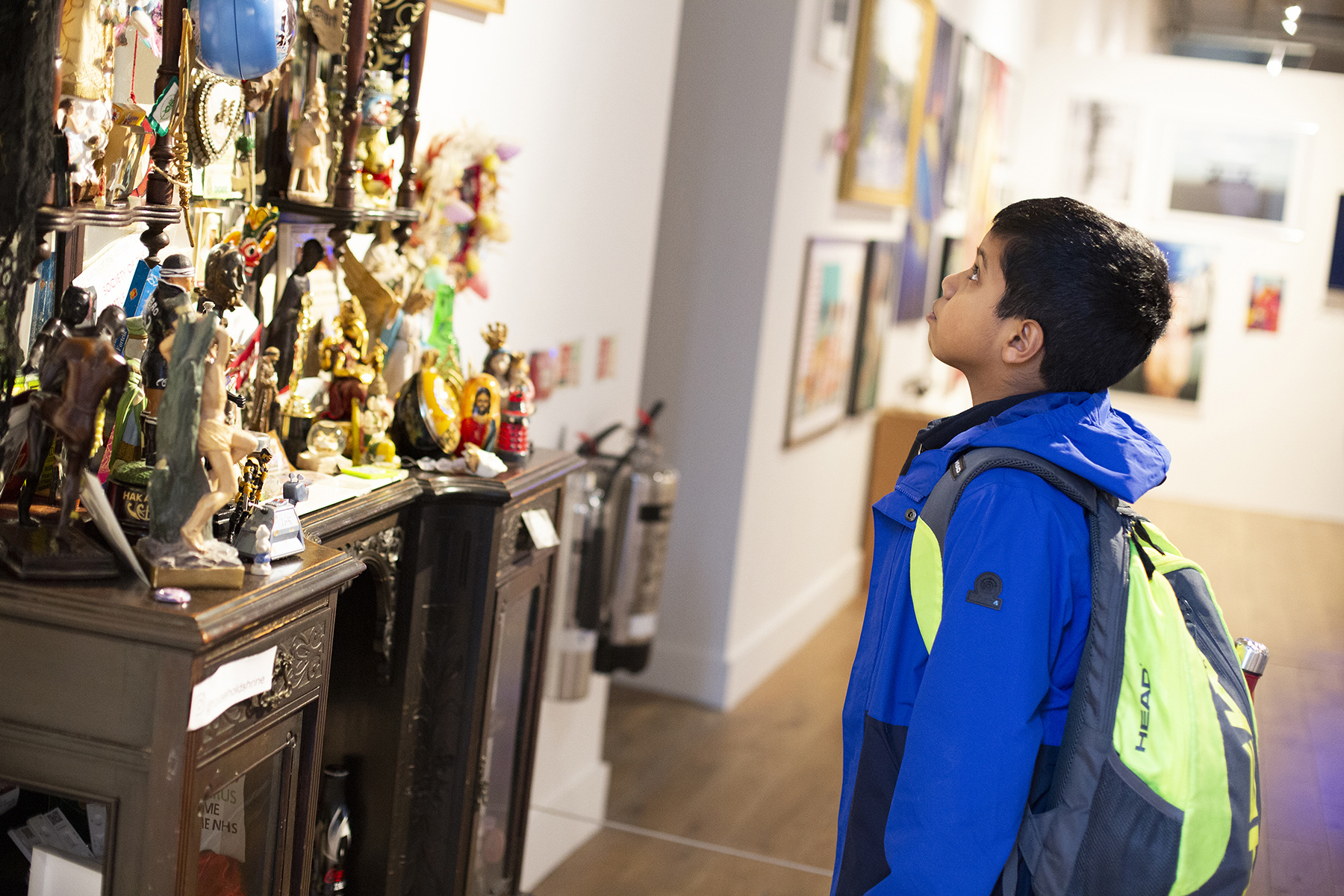 A boy looking at busy artwork during a Creatives Now event