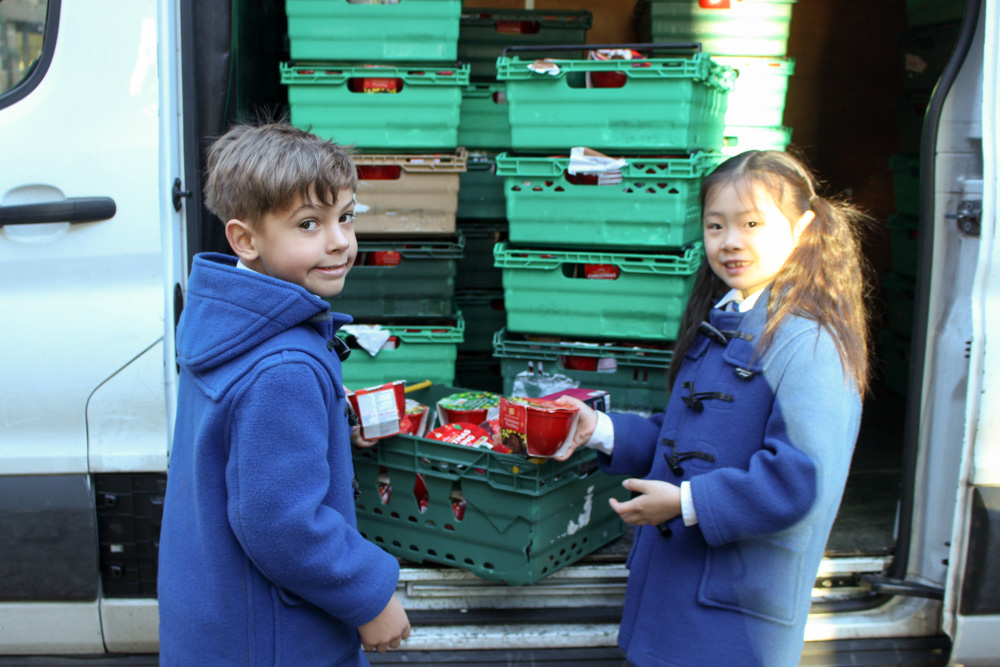 Beech House children at Bolton School packing Christmas Puddings into the Urban Outreach van
