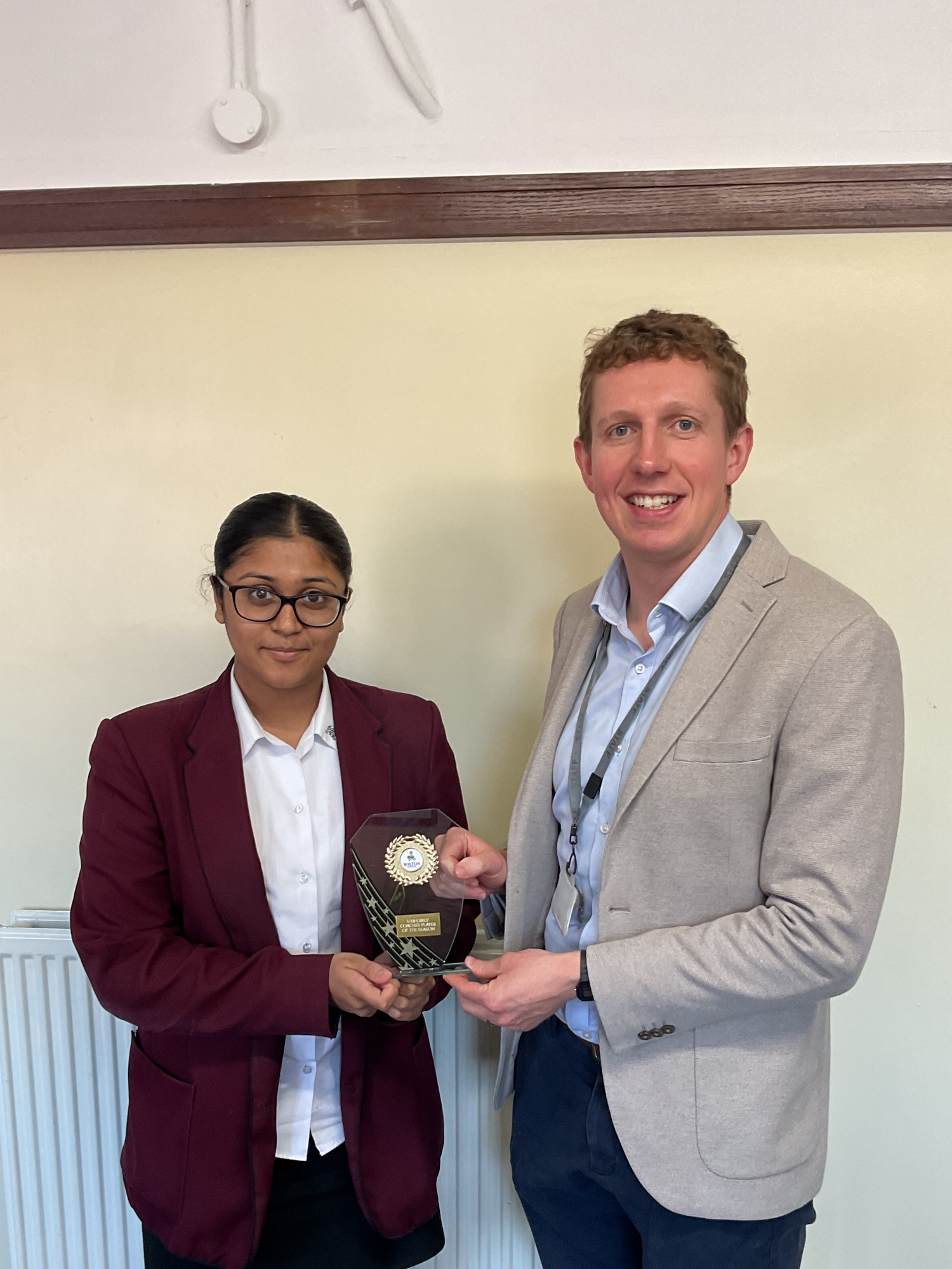 Sonal receiving her Coaches' Player of the Season award from Mr Teasdale